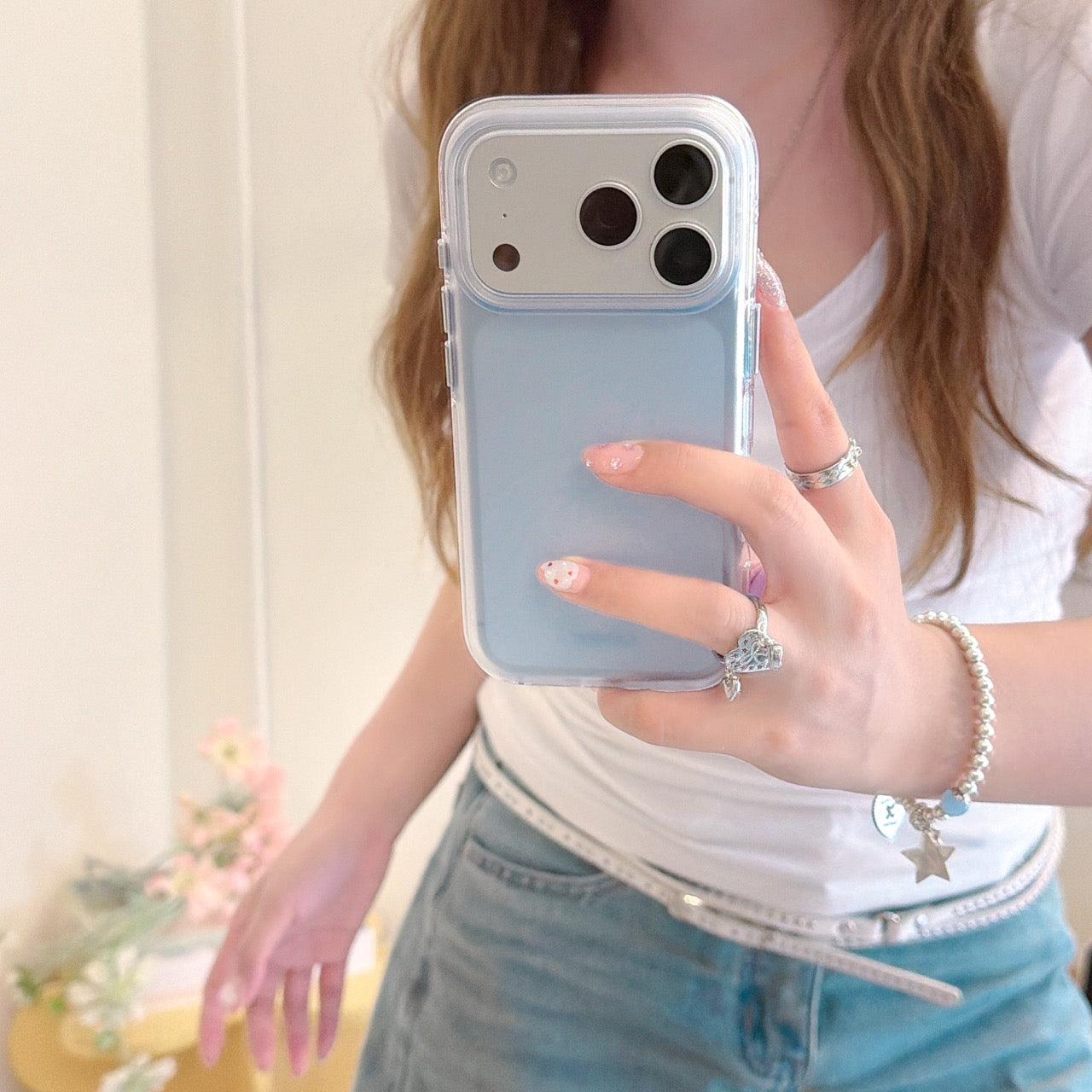 Close-up of a light blue BAFFKKAF phone case with a silver camera protection module held during a selfie.