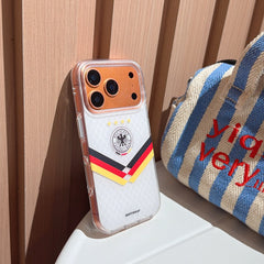 An angled shot of the luxury gold camera rim Germany football mirror case leaning against a wooden wall.