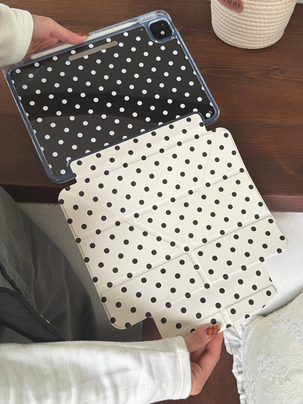 An open view of a magnetic detachable smart ipad folio showing the detached ivory polka dot front flap and a clear back casing.