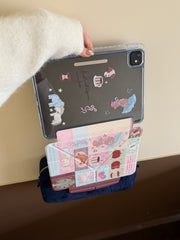 Demonstrating the strong magnetic split feature of a kawaii iPad case with the printed clear back shell hanging securely above the front cover.