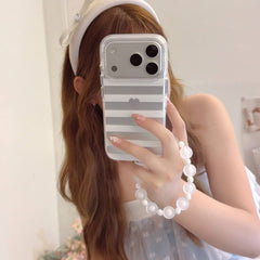 Mirror selfie with gray striped heart iPhone case and white bead strap