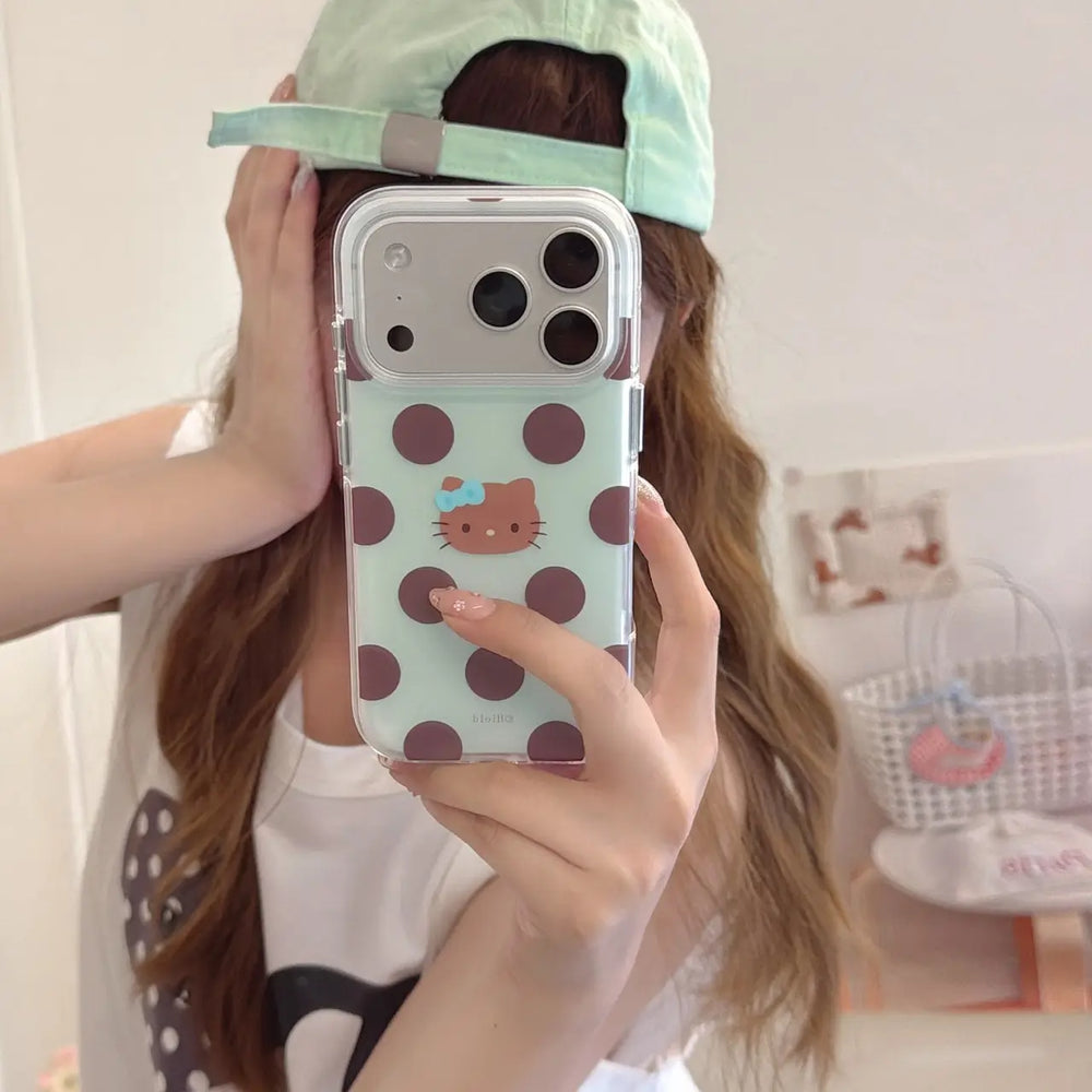Mirror selfie showing mint brown polka dot kitty iPhone case