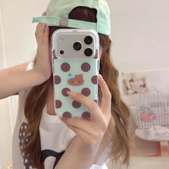 Mirror selfie showing mint brown polka dot kitty iPhone case