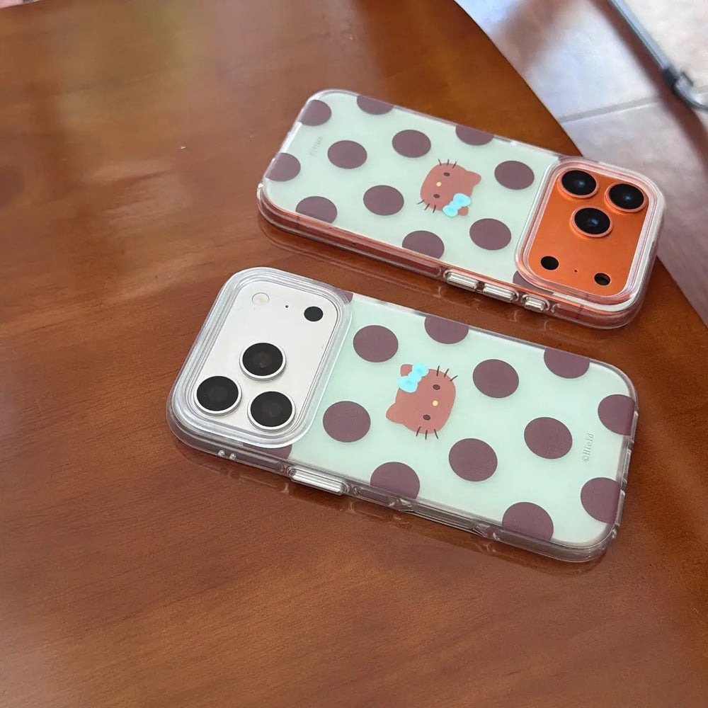 Two mint chocolate polka dot kitty iPhone cases on wooden table