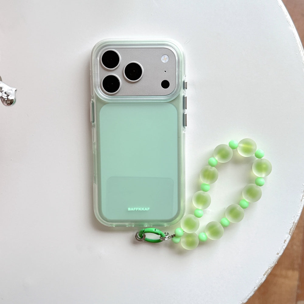Mint green aesthetic iPhone case featuring a matte back panel and a green translucent beaded lanyard charm on white.
