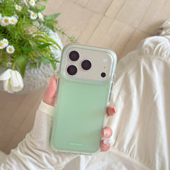 A hand displaying a mint green cute phone cover next to a beautiful bouquet of white daisy flowers.