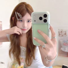 A woman showing a mint green minimalist phone case with a clear shockproof bumper in a mirror selfie.