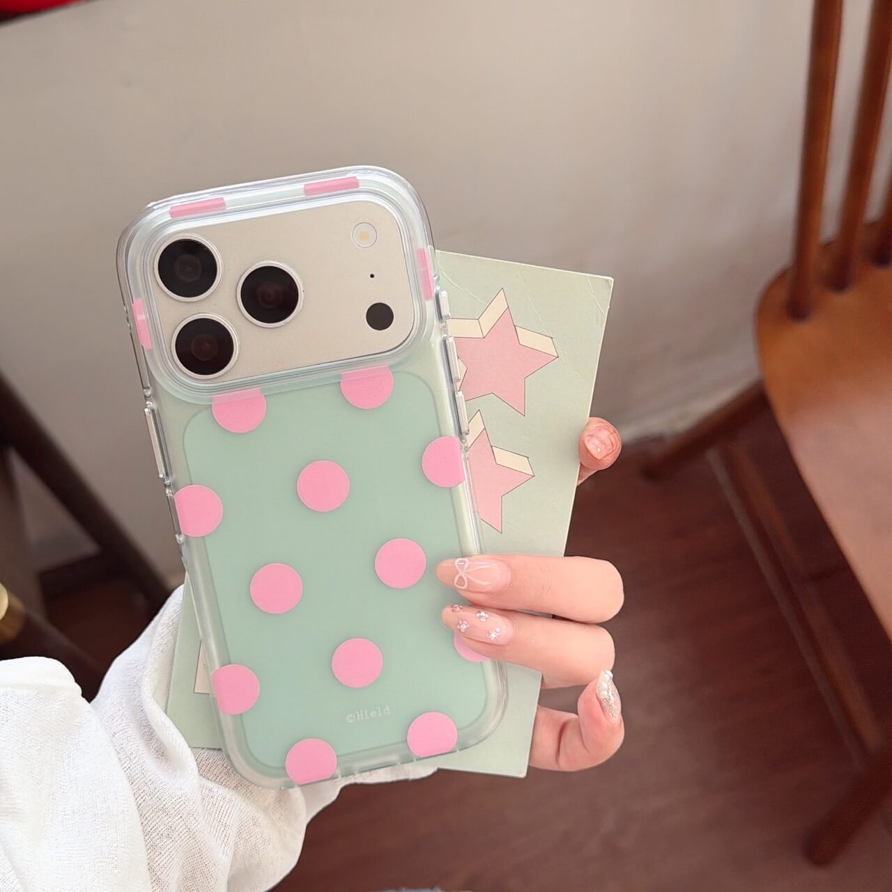 Mint green clear iPhone case with raised pink polka dots