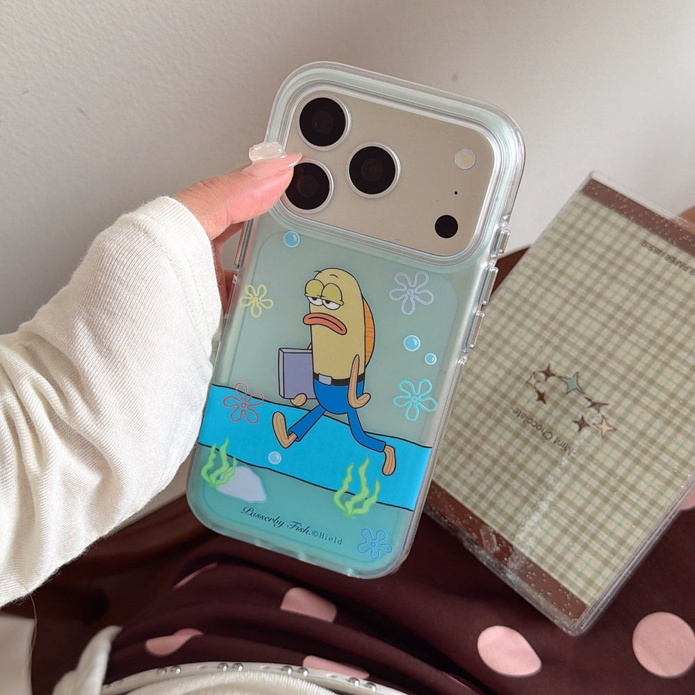 A close-up of a mint green clear phone case featuring a walking cartoon fish character held over a checkered notebook.