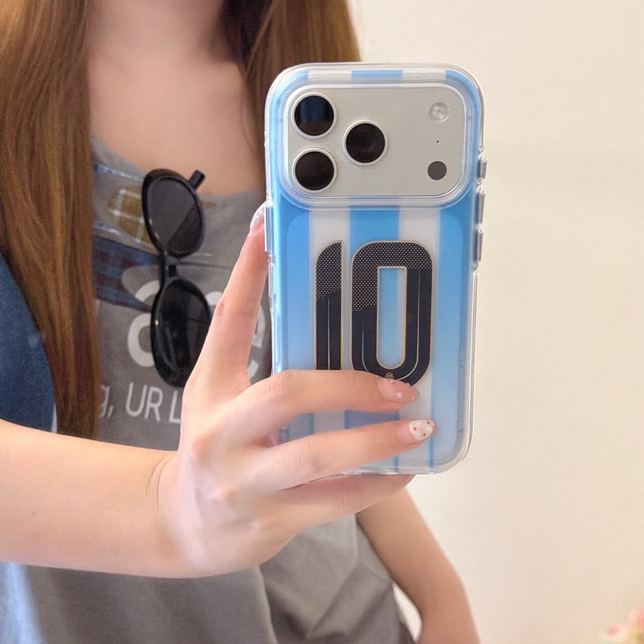 Close-up of a blue striped soccer iPhone case with clear bumper and No.10 design