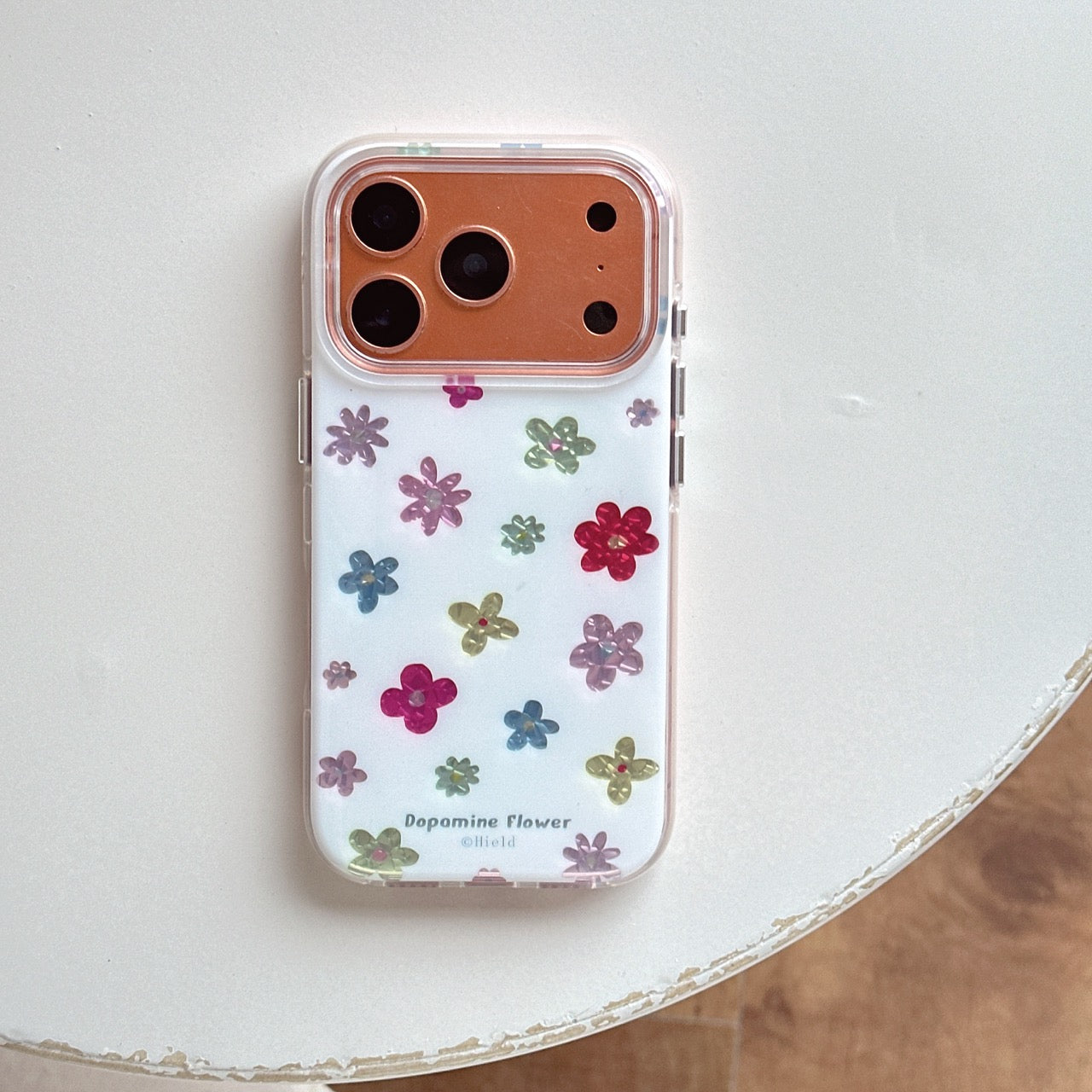 Flat lay of an orange frame dopamine flower clear phone case isolated on a clean white surface.