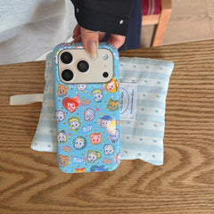 A hand holding an Osamu Goods blue checkered iPhone case over a light blue striped cloth pouch.