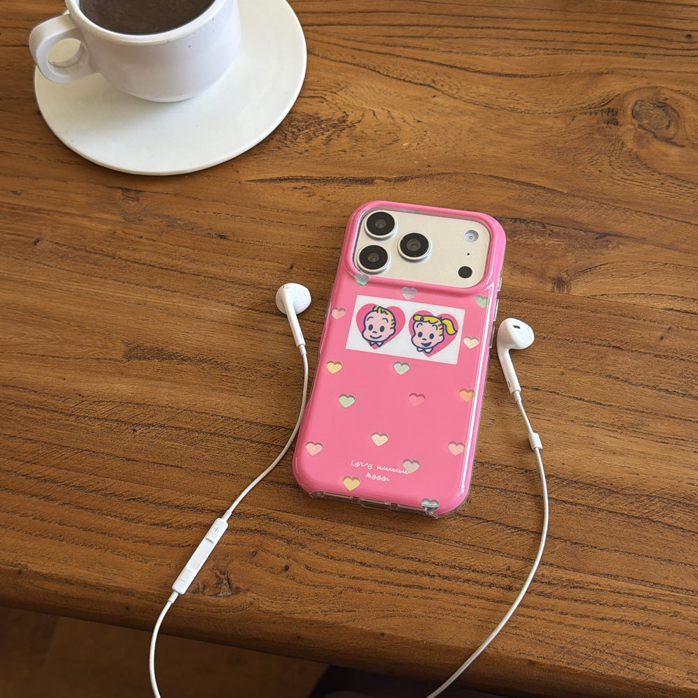 An Osamu Goods pink case on a wooden coffee table next to a white ceramic cup and white earphones.
