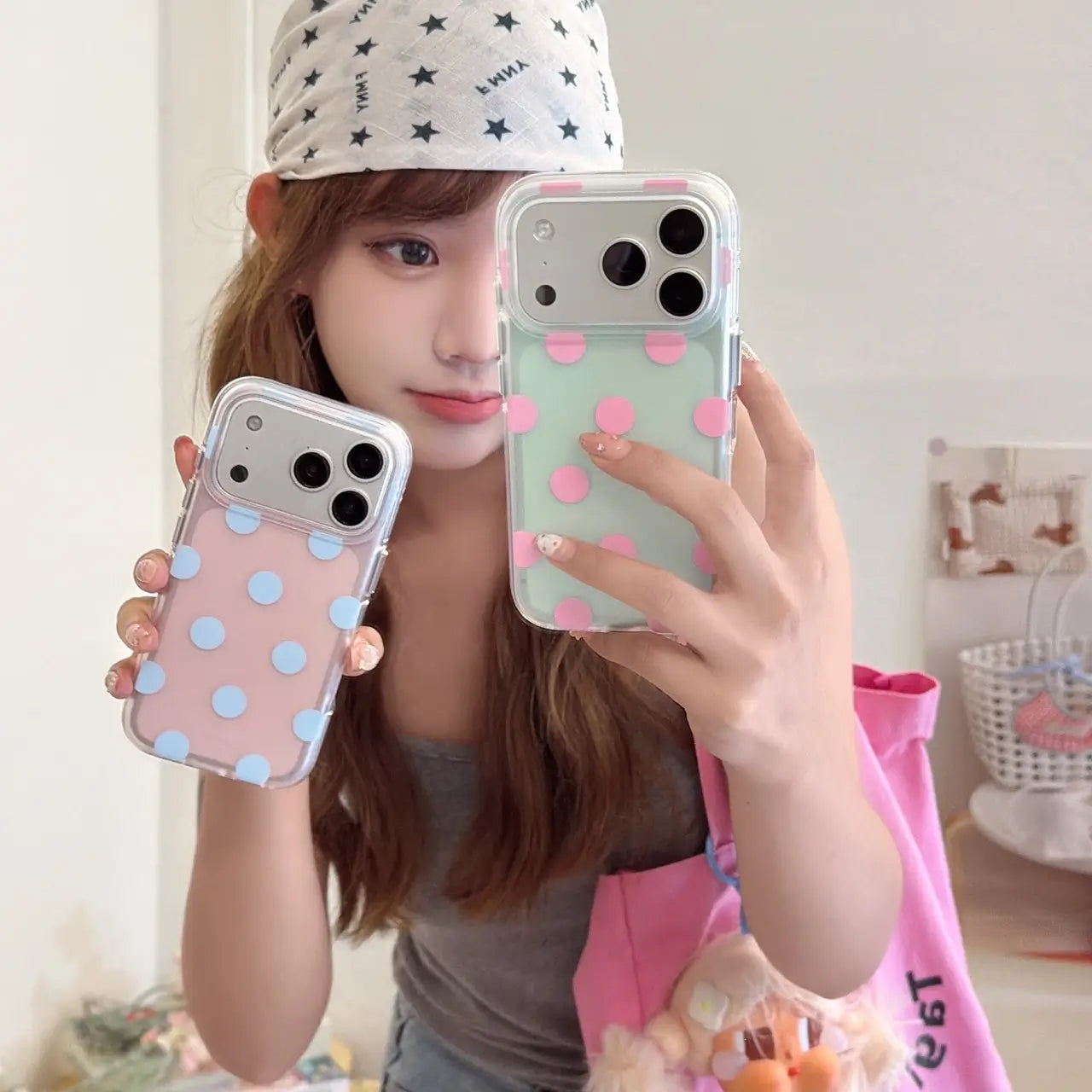 Woman holding pink blue and mint pink polka dot iPhone cases