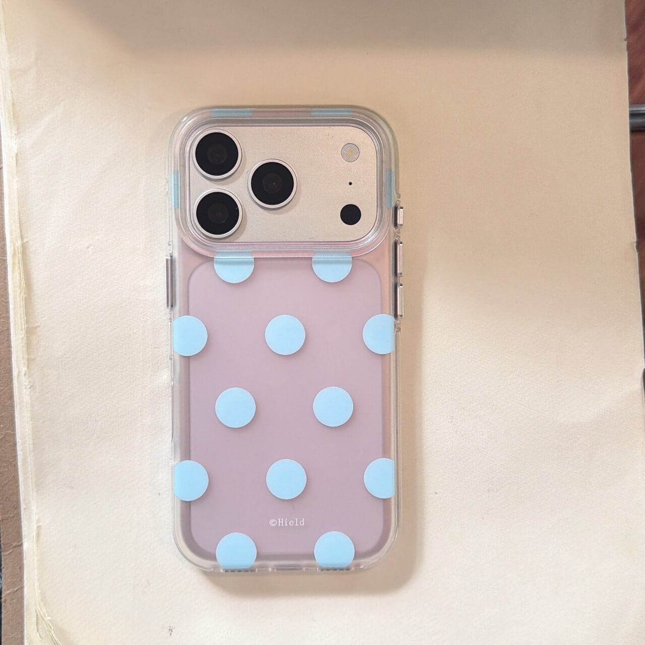 Pink and blue polka dot clear iPhone case on white background