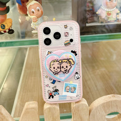 Hand holding a pink clear cartoon iPhone case with round grip design.