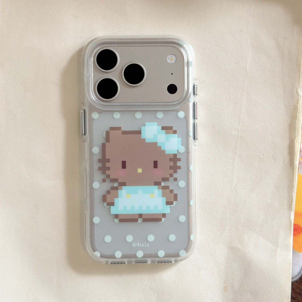 Pixel kitty clear iPhone case with blue bow and polka dot design