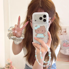 Woman holding a pixel kitty polka dot iPhone case with beaded wrist strap