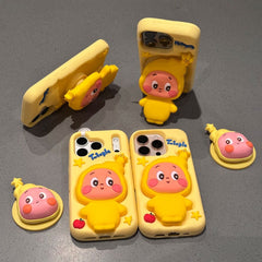 An aesthetic product display on a gray textured surface showing four yellow silicone Twinkle Twinkle phone cases alongside two separate matching 3D character collapsible pop-up sockets, showcasing the expandable grip stand function.
