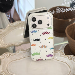 A quirky white mustache phone case standing vertically on an elegant white ceramic display tray.