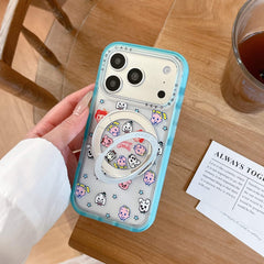 A cute retro anime phone case standing vertically on a wooden table using its silver metal ring stand.