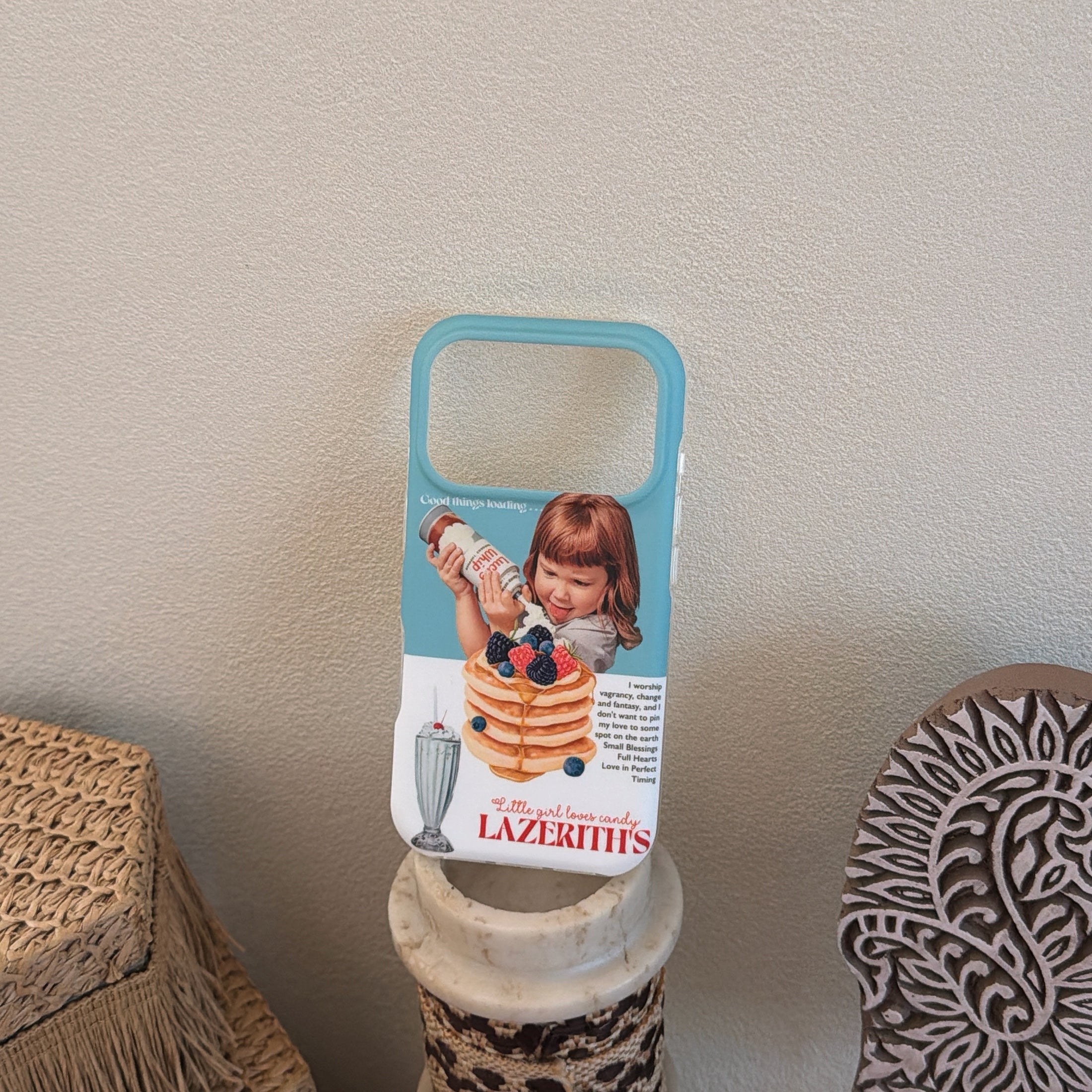 A retro girl pancake phone case displayed vertically on top of a small marble pillar stand.