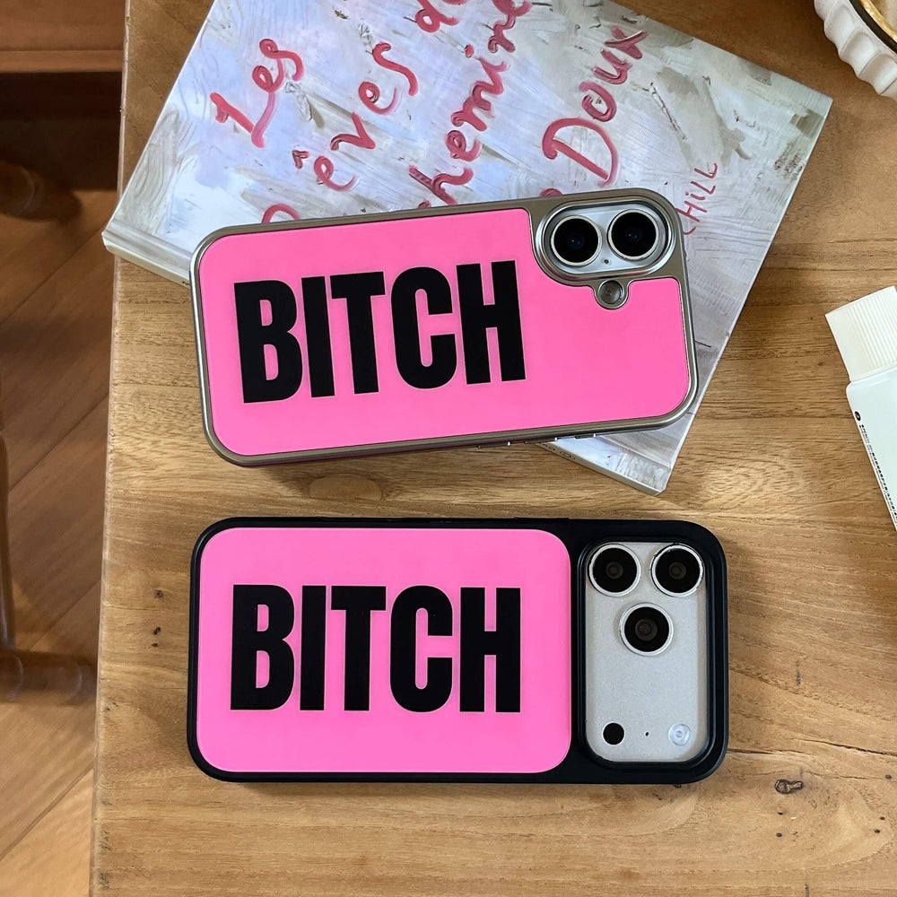 Two hot pink graphic phone cases with silver and black borders arranged on a wooden table.