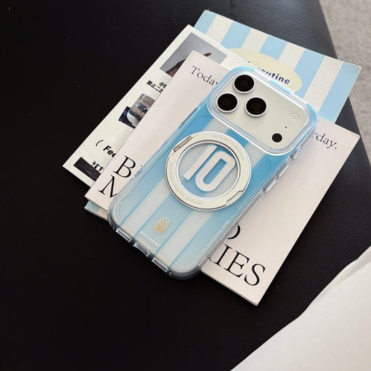 An Argentina sky blue soccer stripe iPhone case lying flat on magazines.