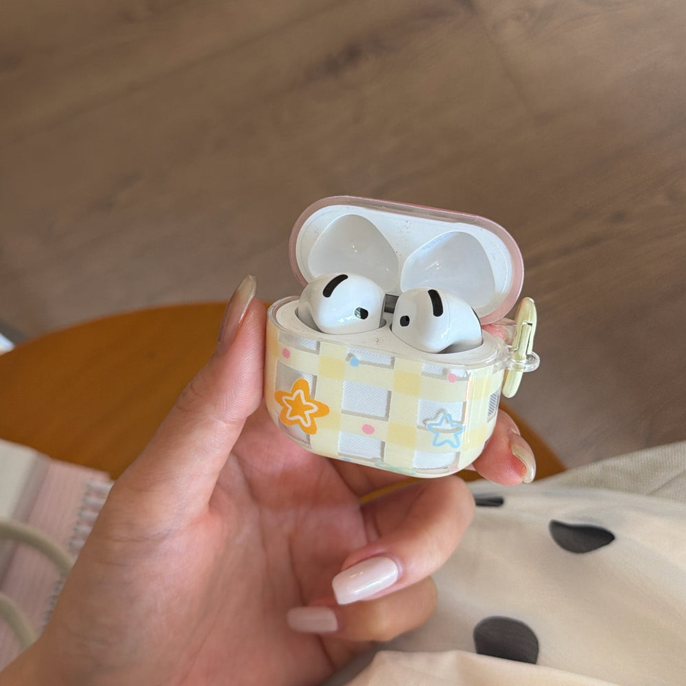A hand-held view of an open clear pastel AirPods case showcasing the precise internal fit for earbuds.