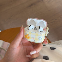A hand-held view of an open clear pastel AirPods case showcasing the precise internal fit for earbuds.