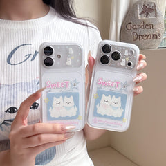 A person holding two soft girl aesthetic clear phone cases with cute white puppy cartoon illustrations.