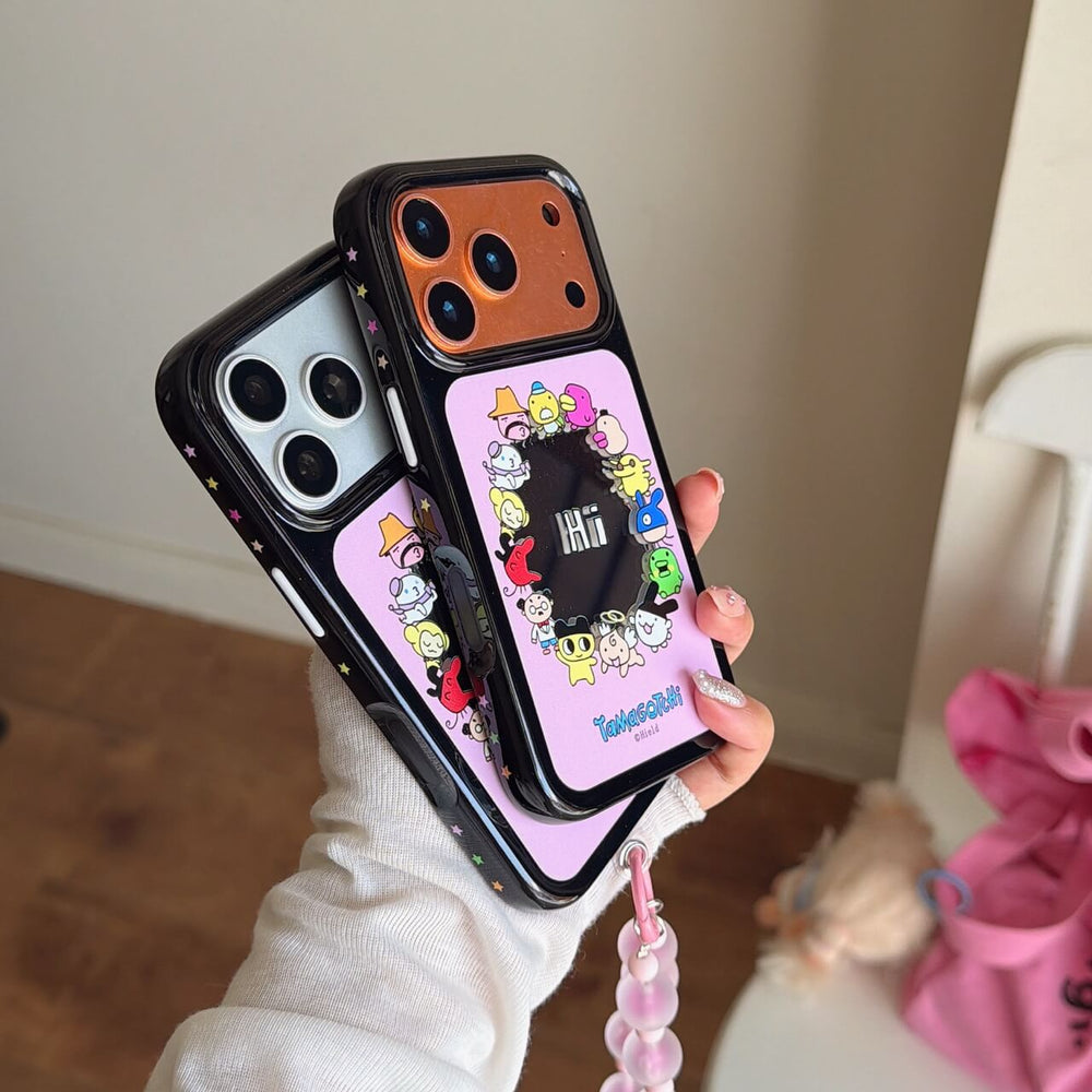 Hand holding stacked Tamagotchi phone cases showcasing the star-patterned black shockproof bumper edges.