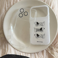 A transparent iPhone case with a cute dog insert resting on a white ceramic plate.
