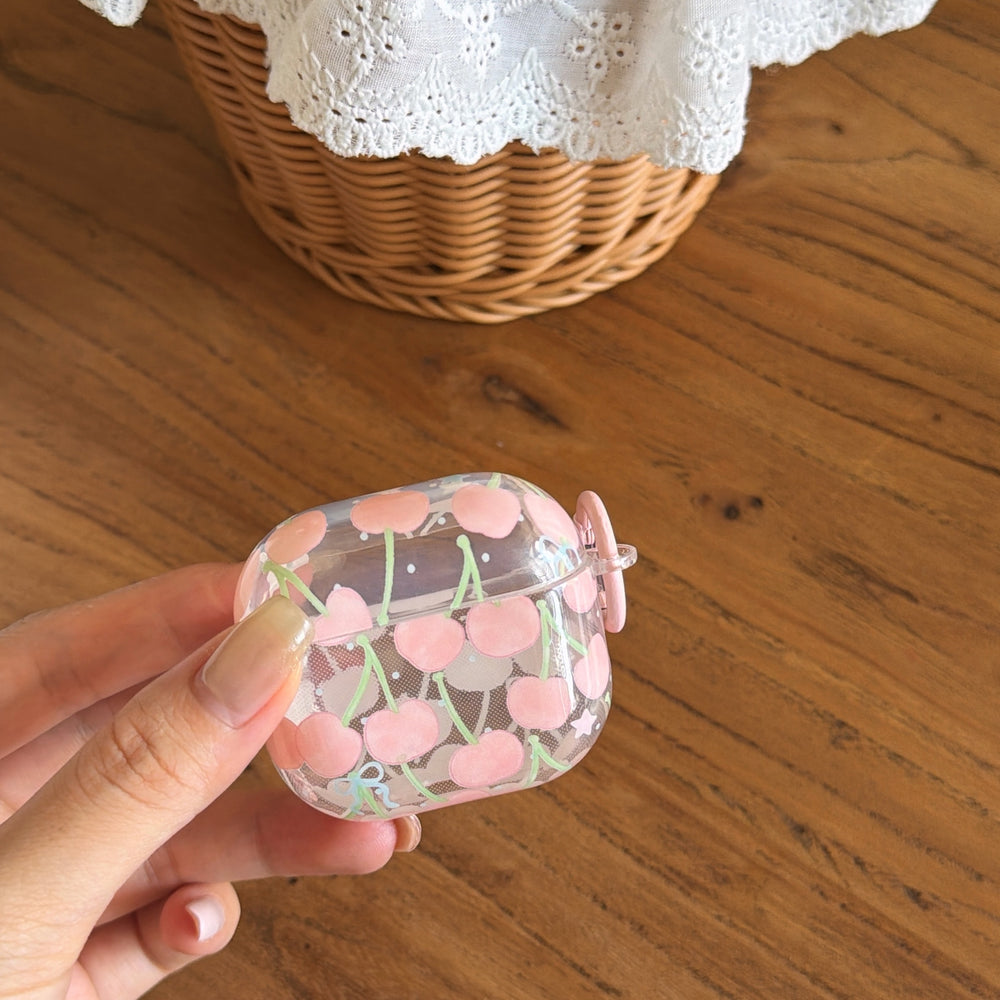 A hand holding a transparent pink cherry AirPods case to showcase its clear protective shell.