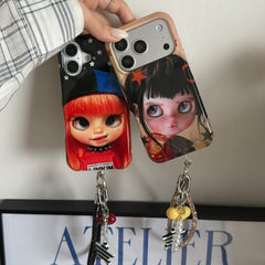 Two Y2K doll iPhone cases with black and champagne charm wrist straps.