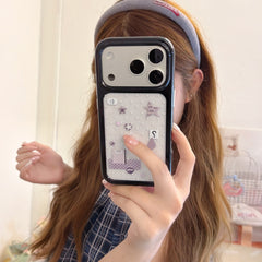 Girl taking a mirror selfie holding a silver Y2K mirror iPhone case with cute star patterns and a black bumper.