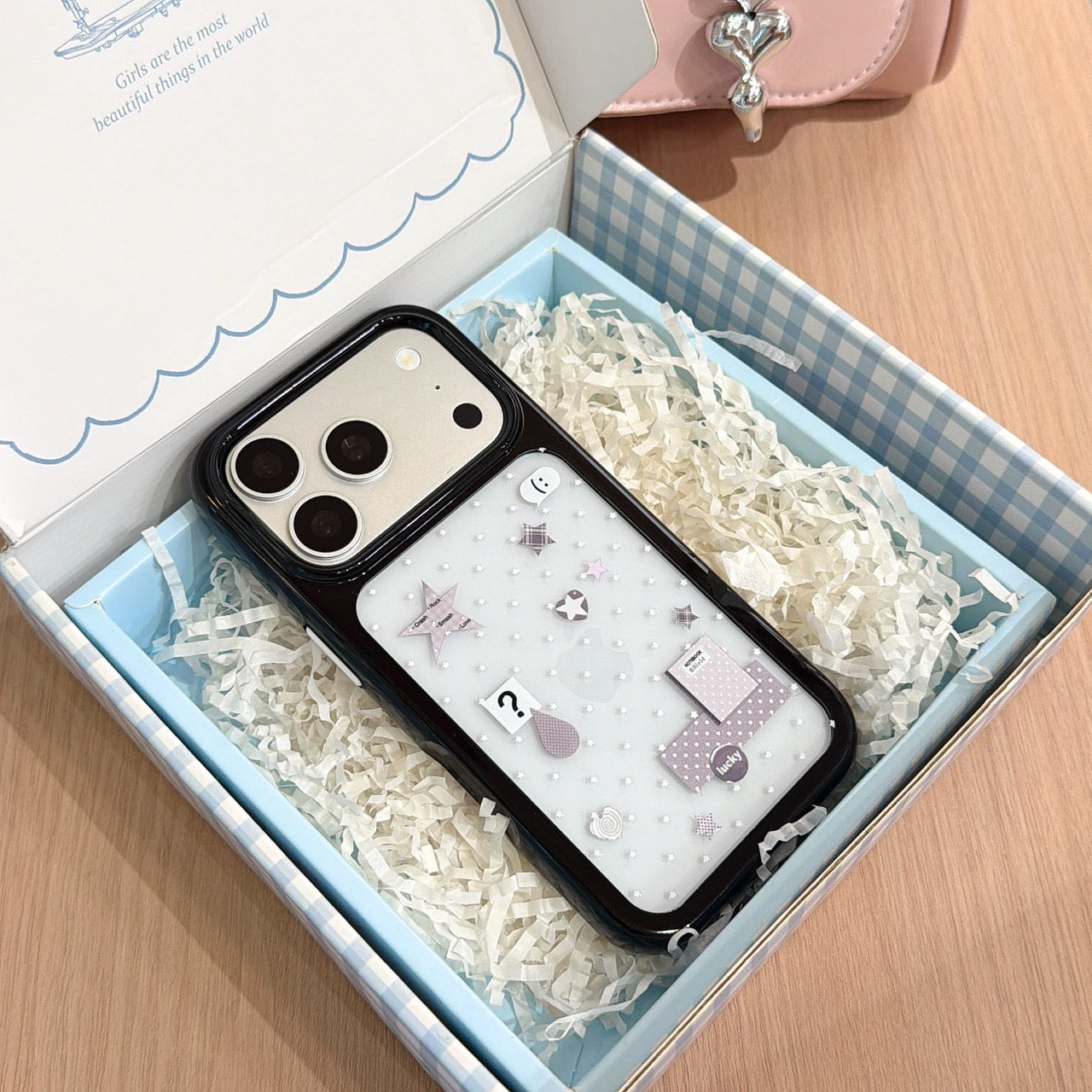 A Y2K silver mirror iPhone case carefully packaged inside a blue checkered aesthetics gift box.