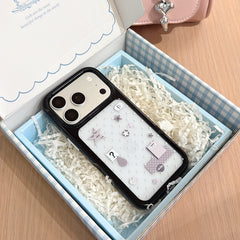 A Y2K silver mirror iPhone case carefully packaged inside a blue checkered aesthetics gift box.